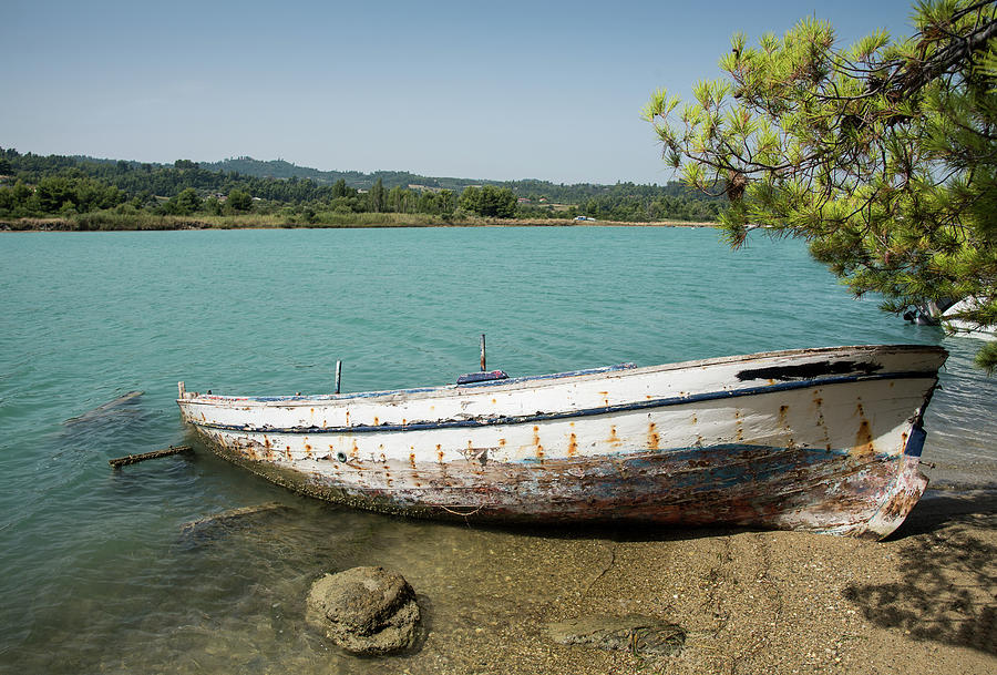 Fishing wooden boat reasting on the coast Photograph by Michalakis Ppalis