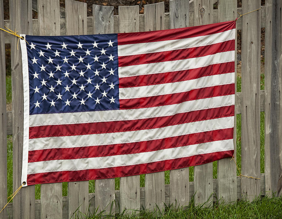 Flag on a Fence Photograph by Phil Cardamone