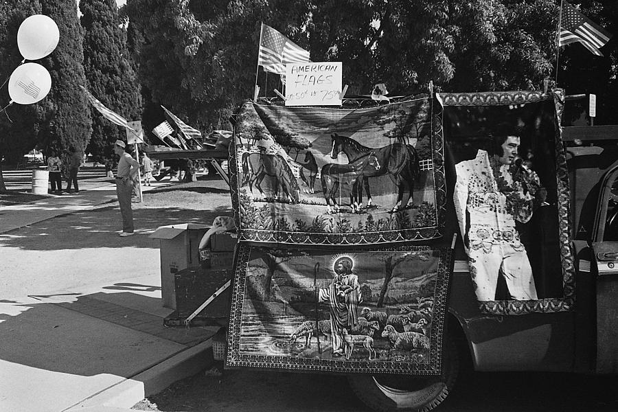 Flags  and Elvis Presley tapestries vendor Veterans day Armory Park Tucson AZ 1986  Photograph by David Lee Guss