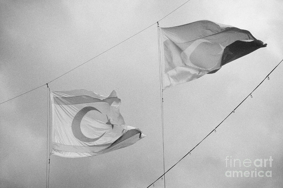 Flag Photograph - flags of turkey and TRNC turkish republic of northern cyprus flying in the sky above nicosia cyprus by Joe Fox
