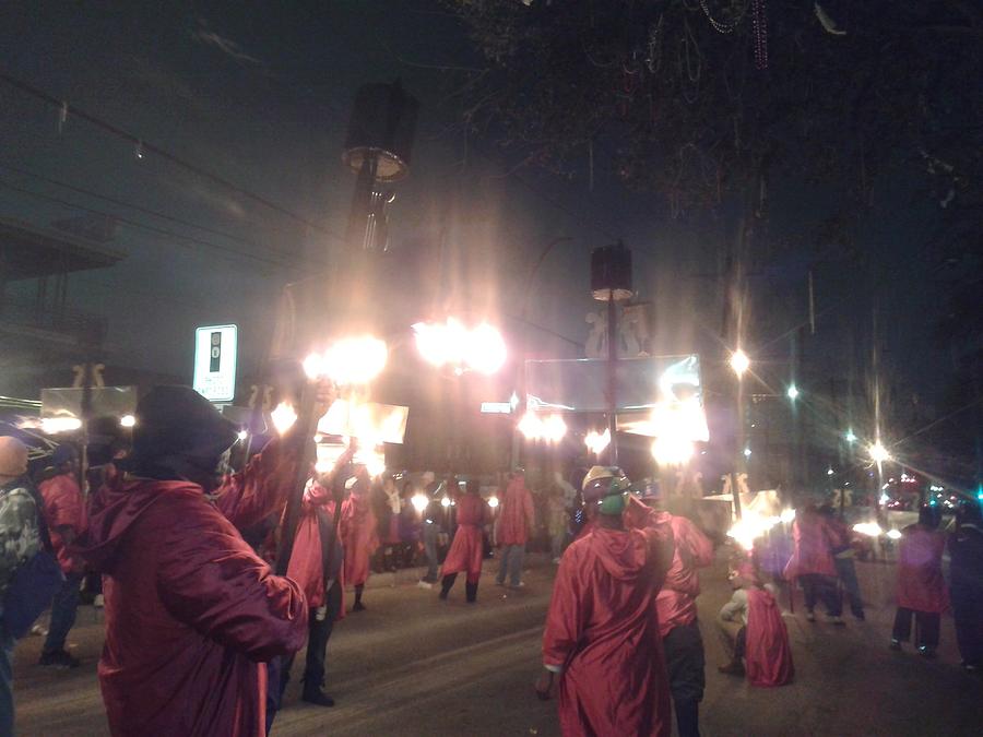 Flambeau Carriers Illuminate The Streets During  Lundi Gras  Photograph by Michael Hoard