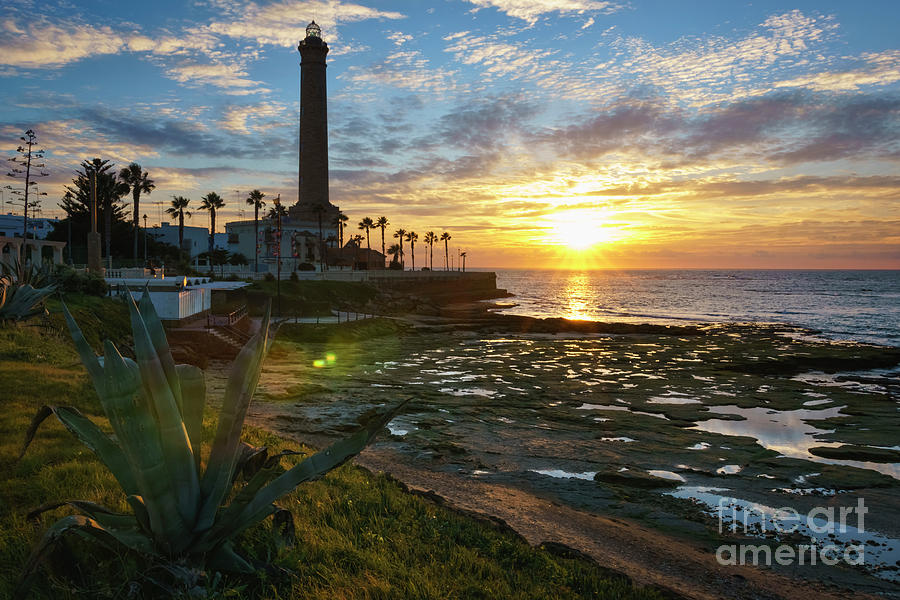 Flaring Sun at Chipiona Lighthouse Cadiz Spain Photograph by Pablo Avanzini