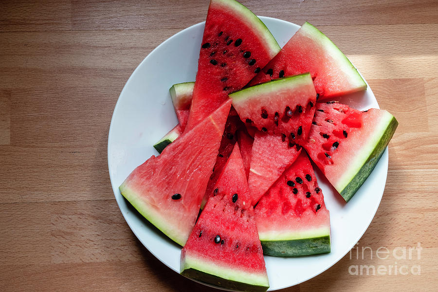 Flat lay of  watermelon on the wooden surface Photograph by Marina Usmanskaya