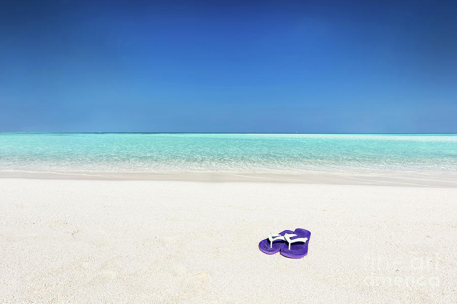 Flip-flops on sand on tropical beach in Maldives Photograph by Michal Bednarek