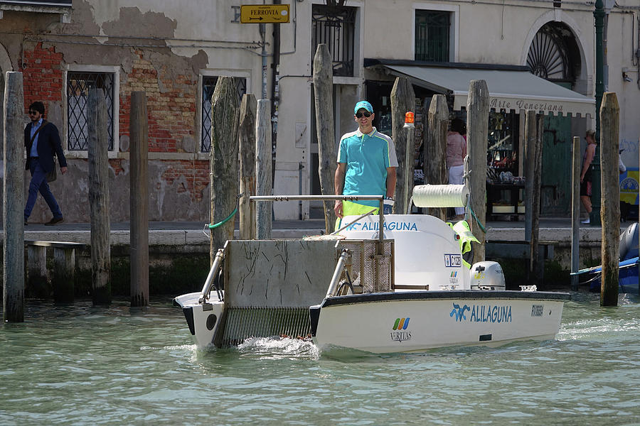 Floating Trash Collection Boat In Venice, Italy Photograph by Rick Rosenshein