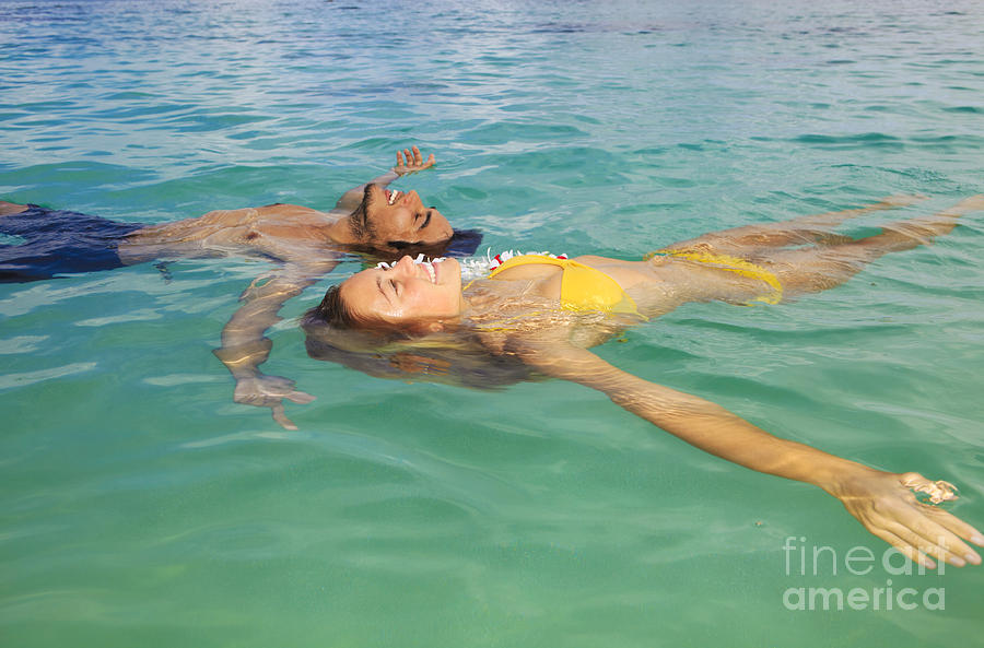 Floating Young Couple Photograph by Tomas del Amo - Printscapes