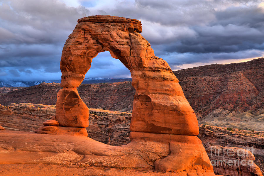 Fluffy Storm Clouds Over Delicate Arch Photograph by Adam Jewell