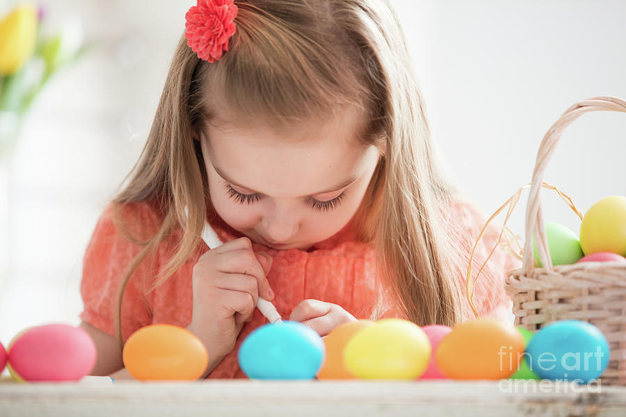 Focused child creating drawings on colorful dyed eggs Photograph by Michal Bednarek