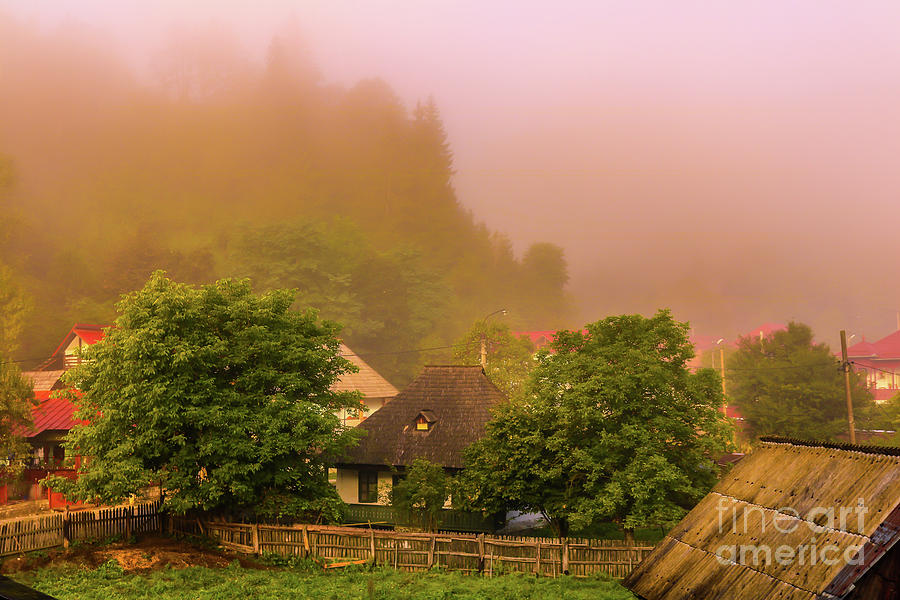 Foggy morning over romanian village Photograph by Claudia M Photography