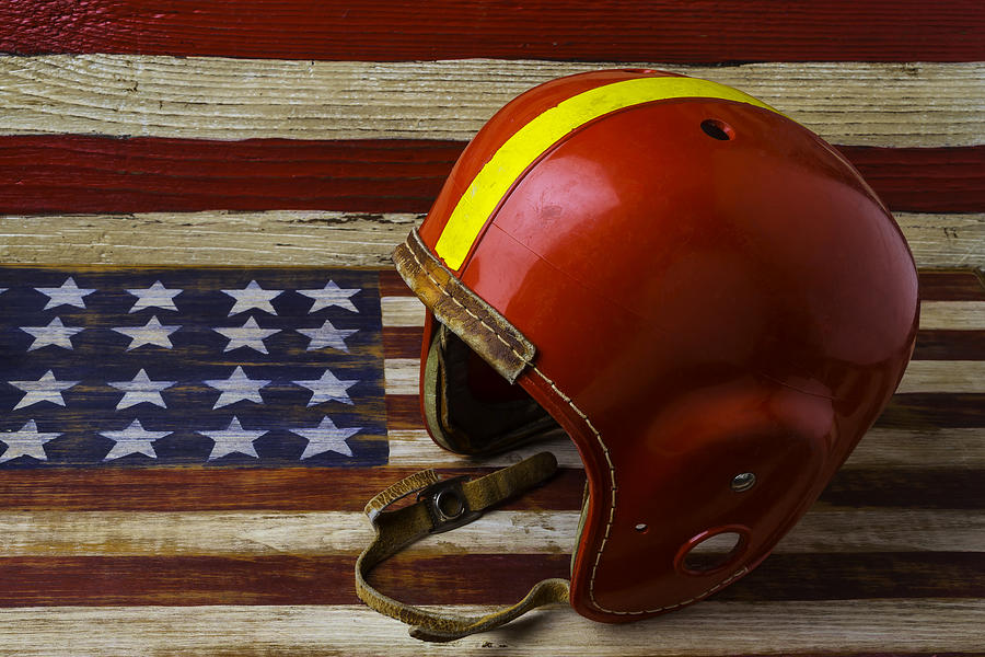 Football Photograph - Football Helmet On American Flag by Garry Gay
