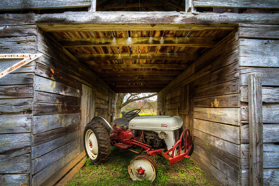 Ford Tractor Hiding in the Barn Photograph by Debra and Dave Vanderlaan