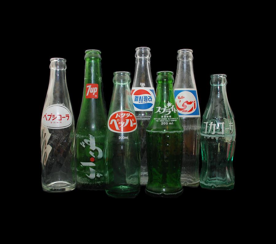 Foreign Cola Bottles Photograph by Rob Hans