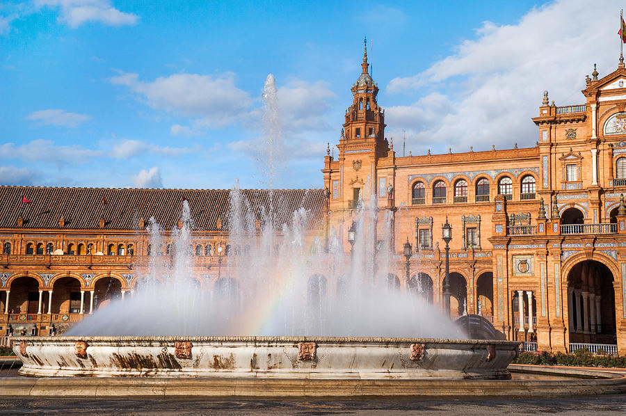 Fountain with Rainbow on Plaza de Espana in Sevillle Photograph by Jenny Rainbow