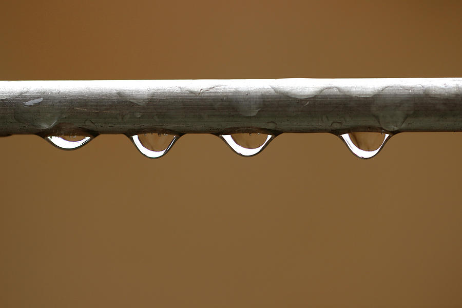 Four Water Droplets on Metal Pipe Photograph by Prakash Ghai