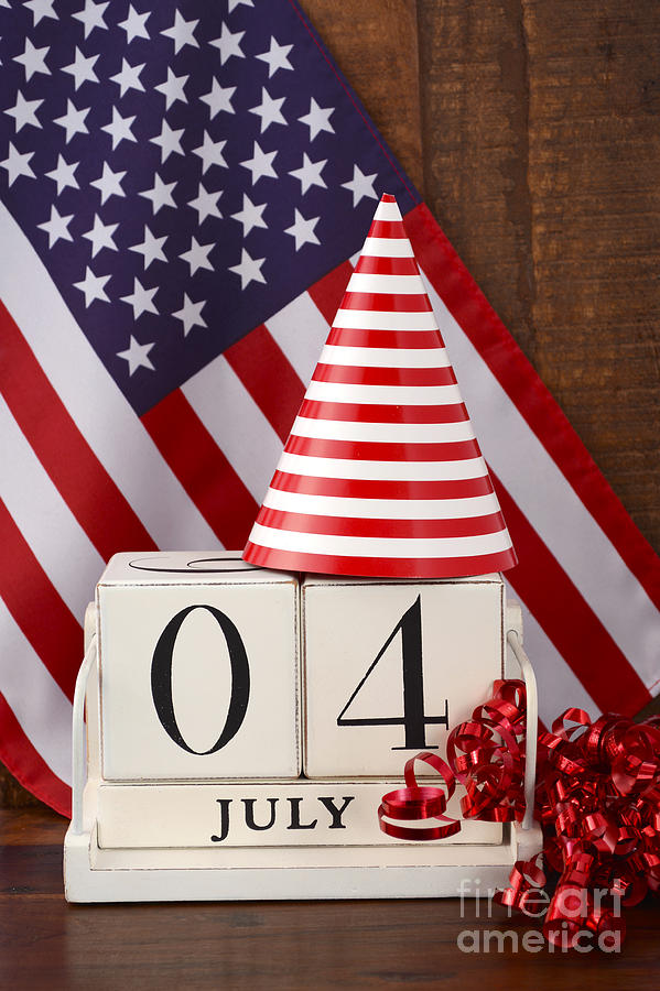 Fourth of July vintage wood calendar with flag background.  Photograph by Milleflore Images