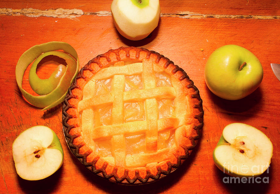 Freshly Baked Pie Surrounded By Apples On Table Photograph