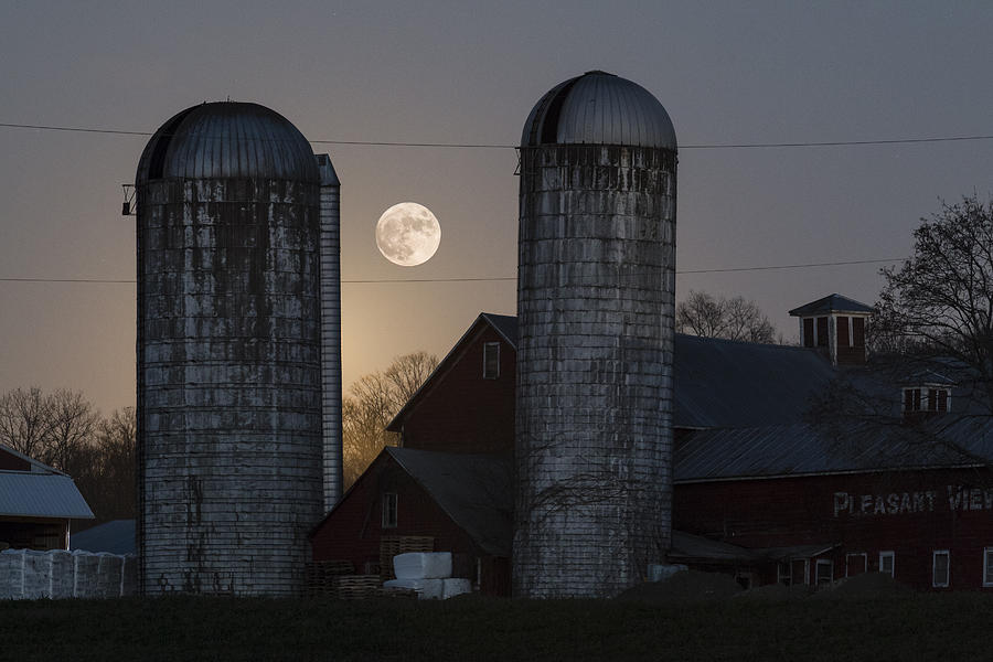 Full moon between the silos Photograph by Tom Bushey - Pixels