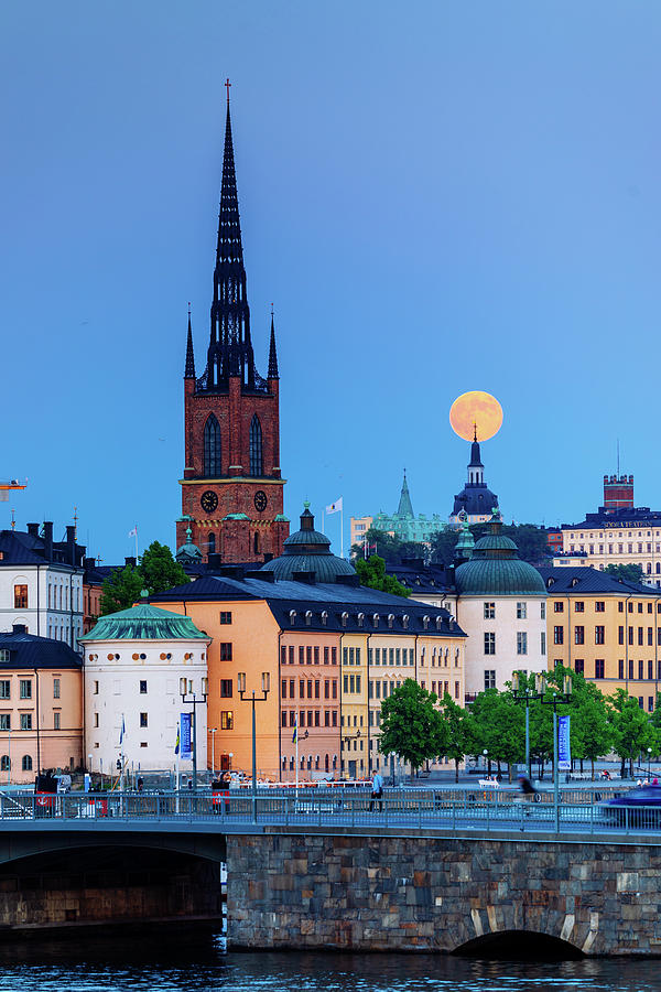 Blue Hour Photograph - Full moon over the Katarina Church and Sodermalm in Stockholm with the Riddarholmen Church in Front by Dejan Kostic Blue Hour Photograph - Full moon over the Katarina Church and Sodermalm in Stockholm with the Riddarholmen Church in Front by Dejan Kostic