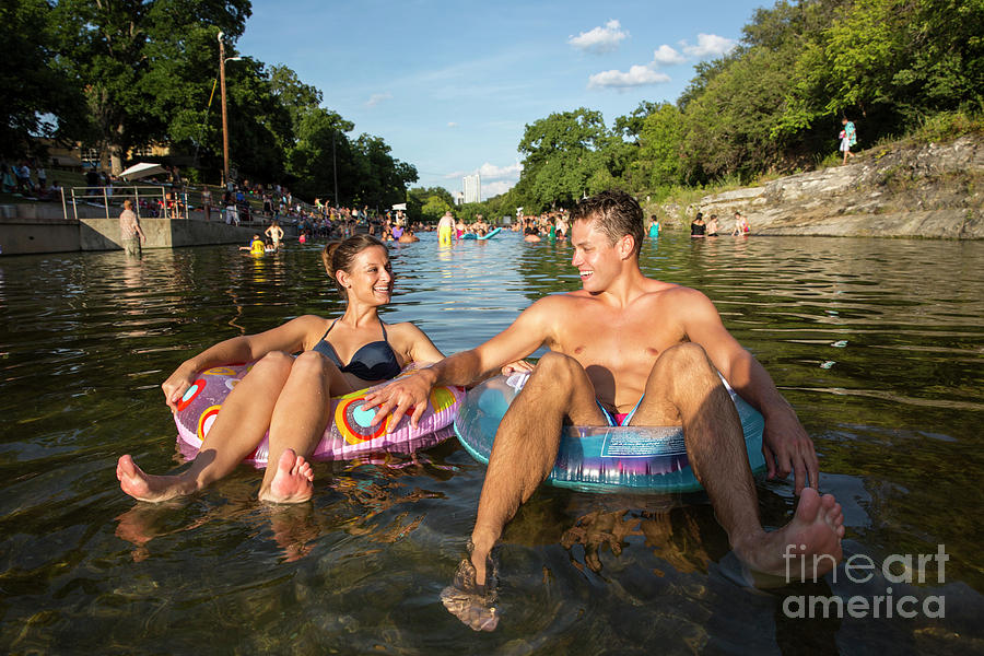 Austin Photograph - Fun couple tubing at Barton Springs Pool - Stock Image by Dan Herron