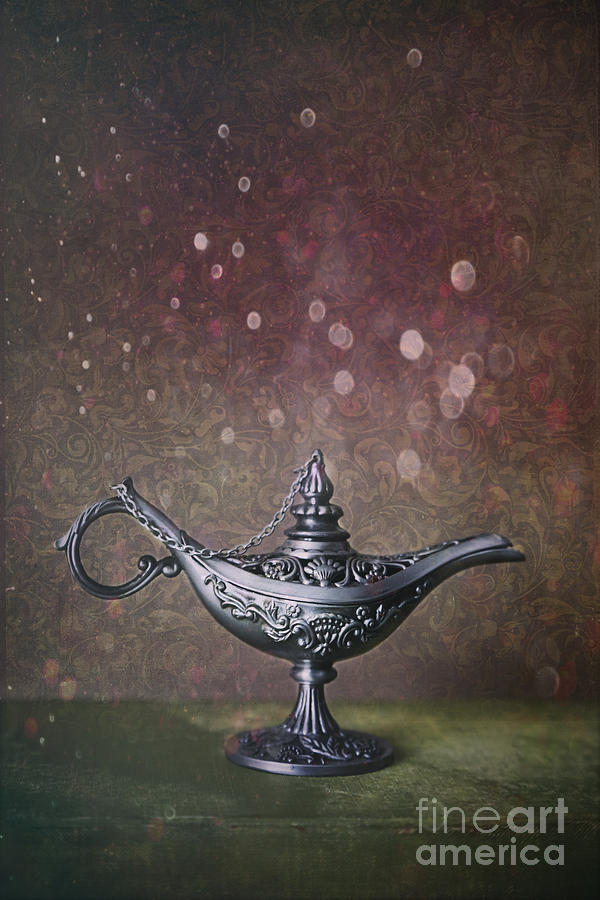 Genie lamp on old book Photograph by Sandra Cunningham