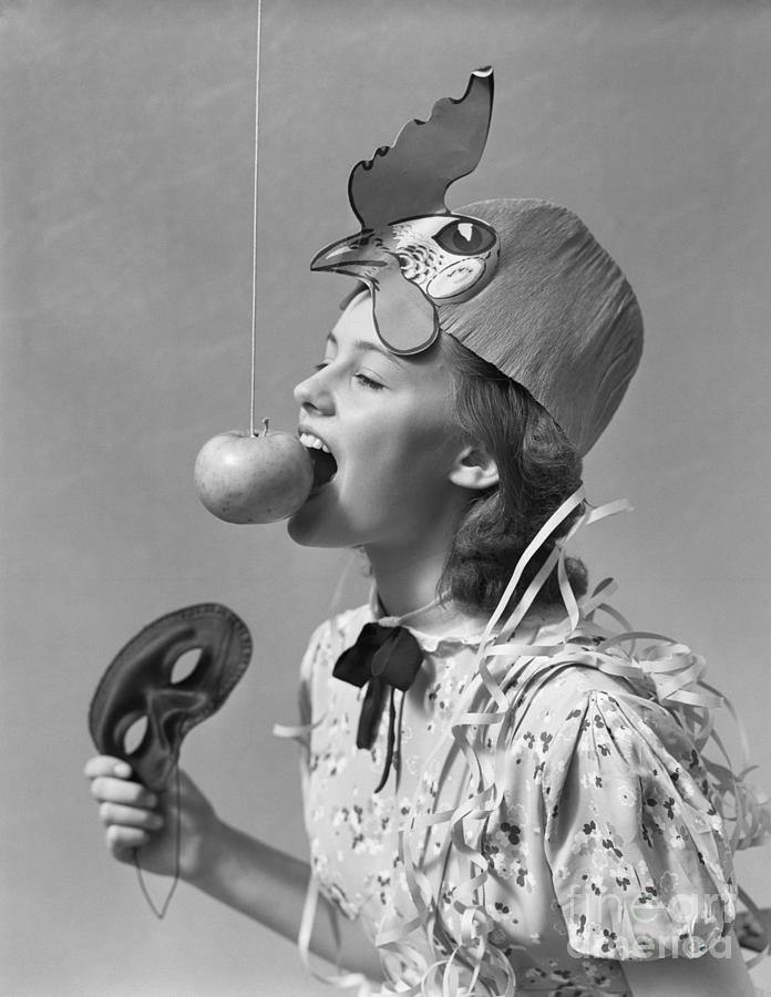 Girl Bobbing For Apple On String Photograph by H. Armstrong Roberts/ClassicStock