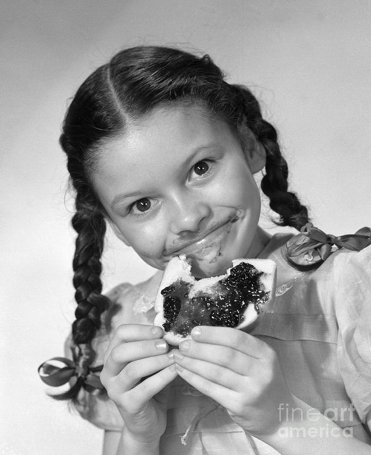 Girl Eating Bread And Jam, C.1950s Photograph by Debrocke/ClassicStock