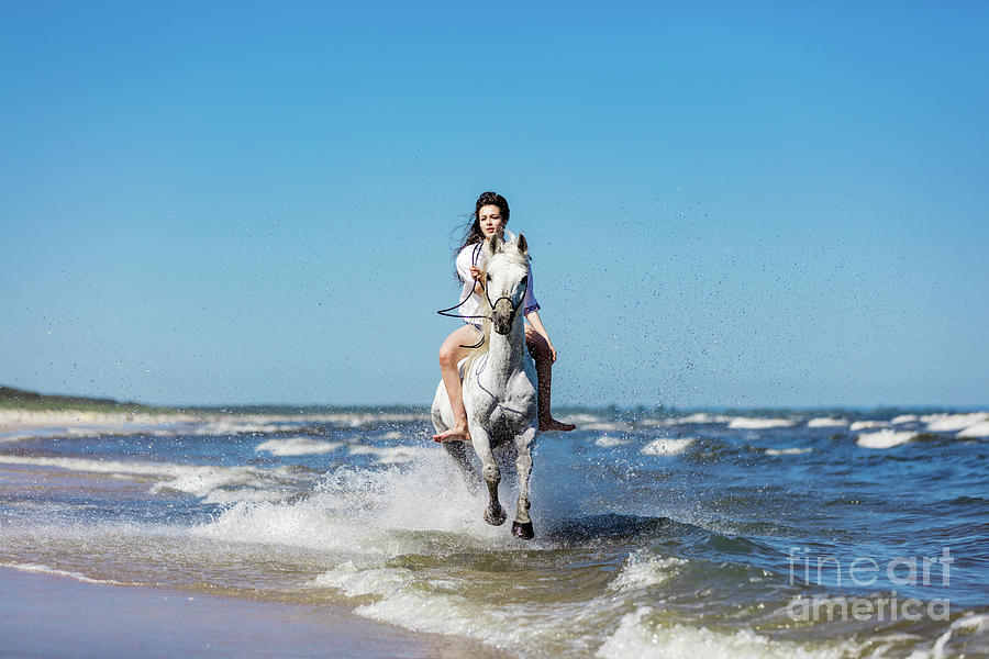 Girl galopading on a white horse in the sea Photograph by Michal Bednarek