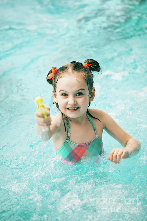 Girl in a swimming pool with a water pistol Photograph by Michal Bednarek