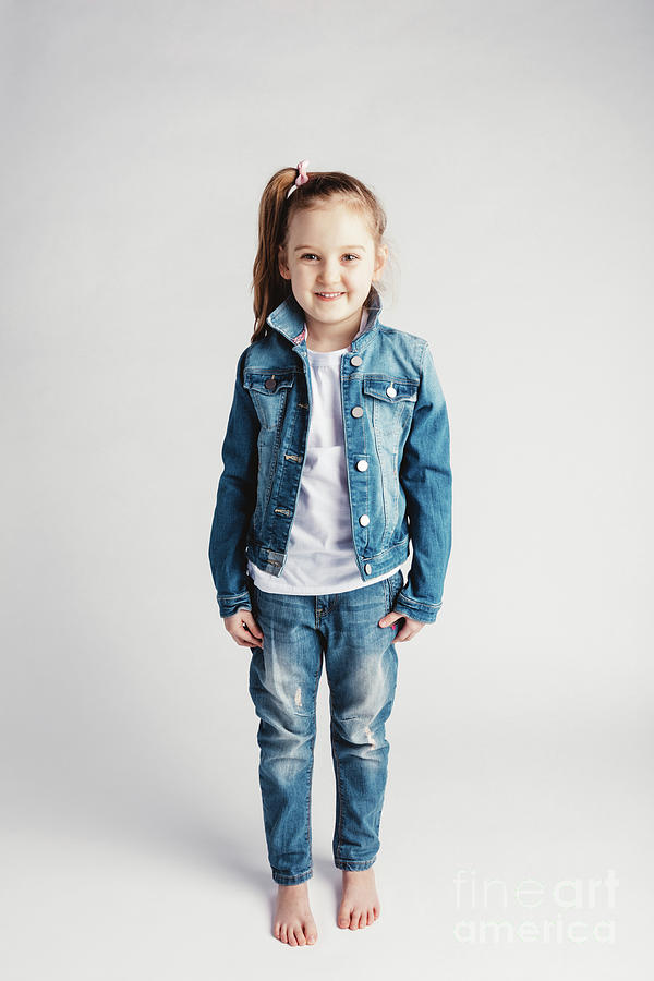 Girl in jeans clothes on white background. Photograph by Michal Bednarek