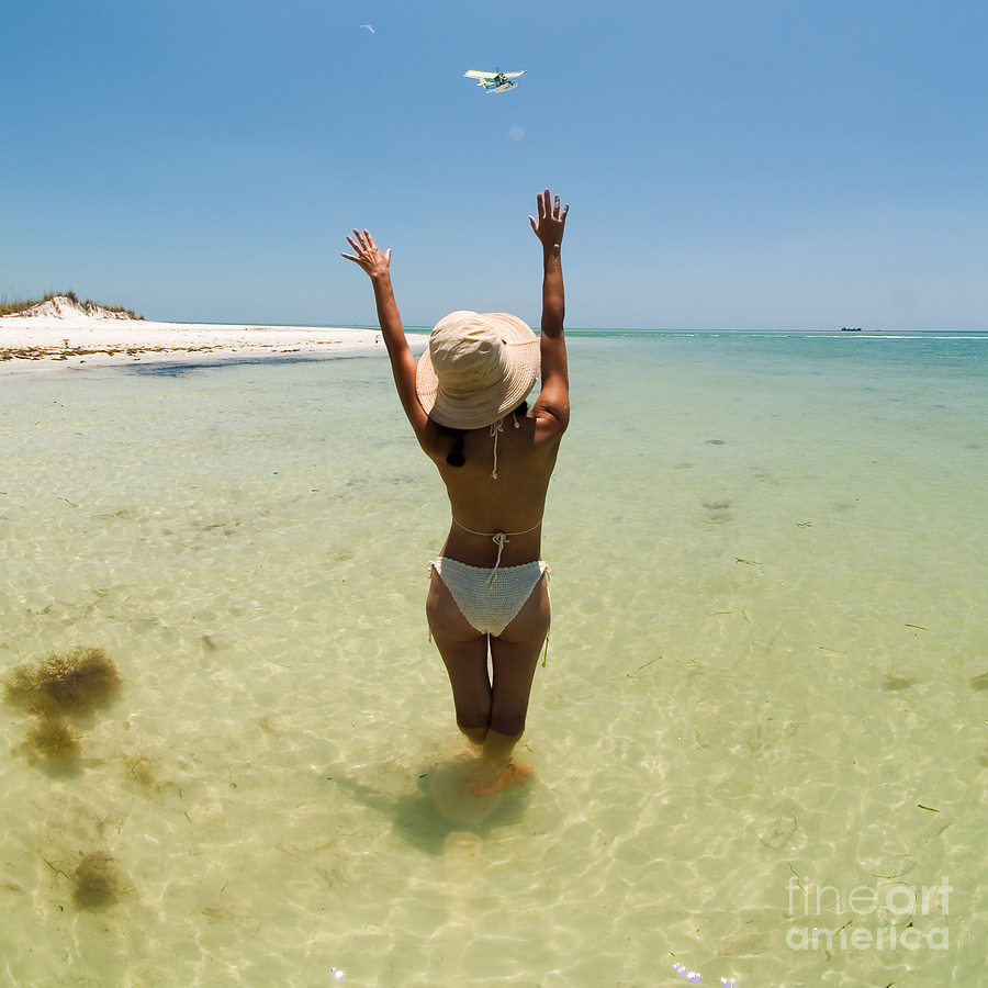 Beach Photograph - Girl on Beach waving to Airplane by Rolf Bertram