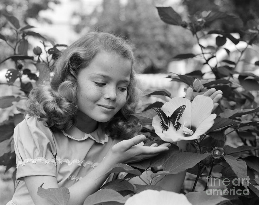 Girl Smiling At A Butterfly, C.1950s Photograph by Debrocke/ClassicStock