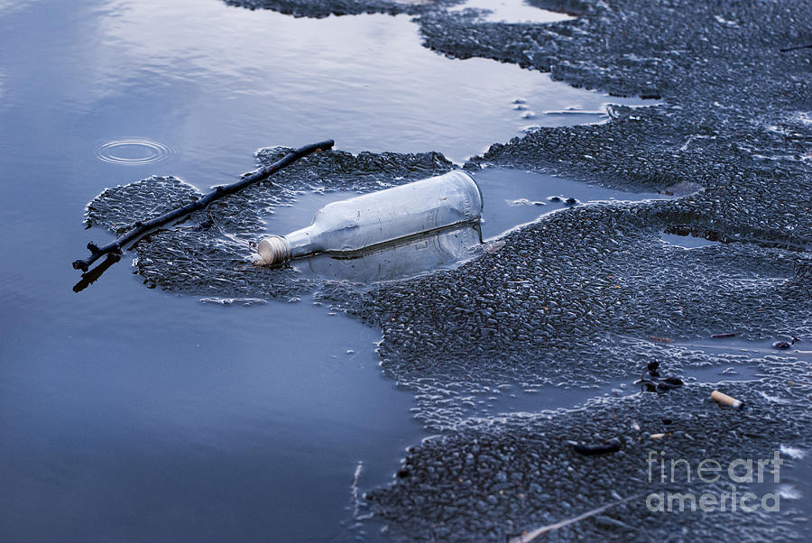Glass Bottle Garbage On Melting Ice On Lake  Photograph by Arletta Cwalina