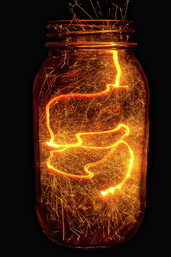 Glass Jar Full Of Sparks Photograph by Garry Gay