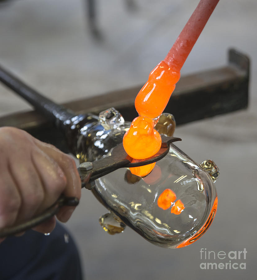 Glassblower cuts molten glass into shape Photograph by Ilan Amihai
