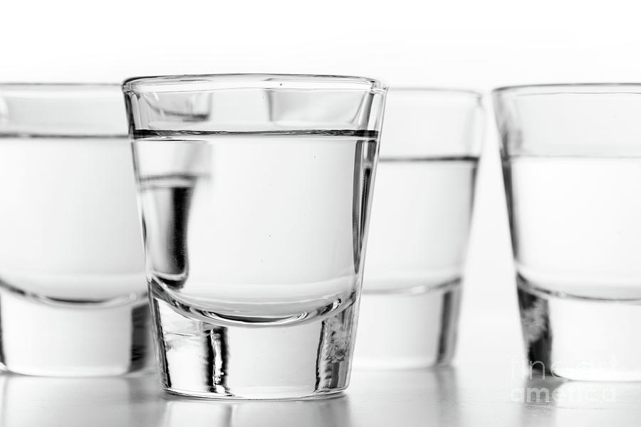 Glasses of vodka on white background. Alcohol Photograph by Michal Bednarek