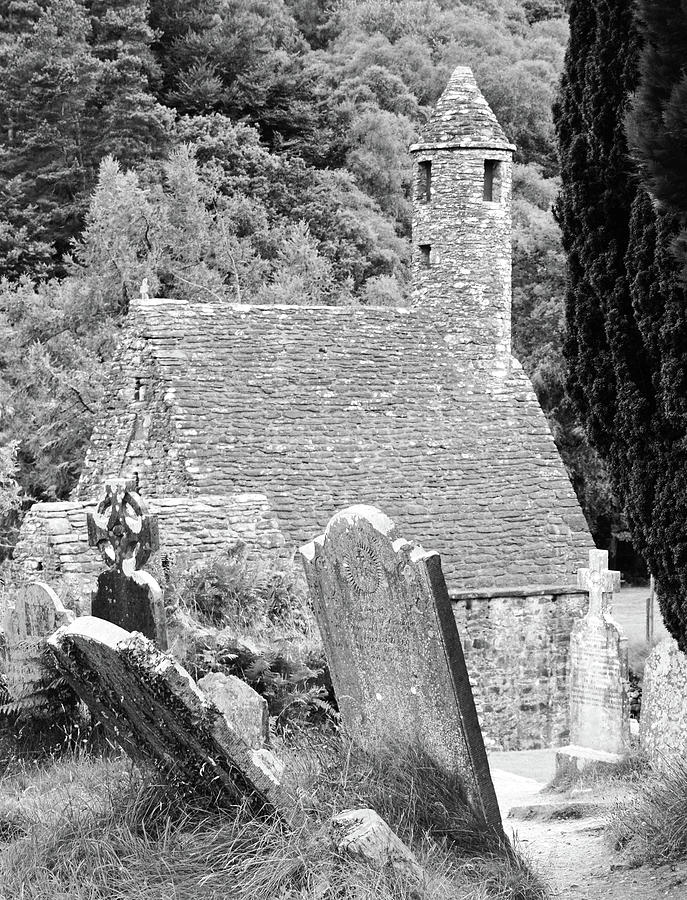 Glendalough Ireland St Kevins Church Behind Headstones Wicklow Mountains Black and White Photograph by Shawn OBrien