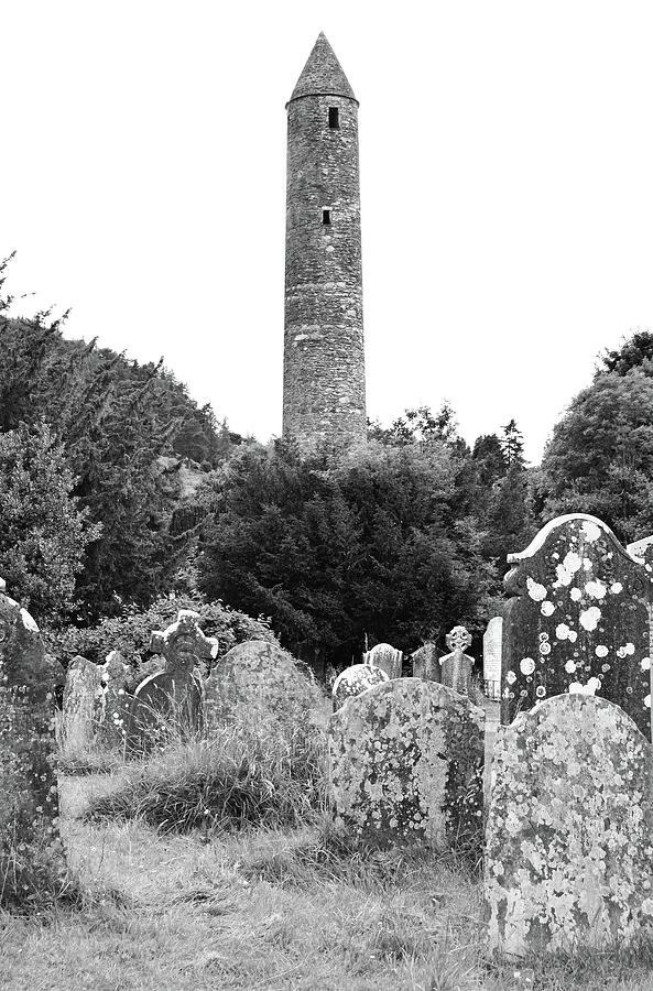 Glendalough Irish Round Tower Above Graveyard Headstones County Wicklow Ireland Black and White Photograph by Shawn OBrien