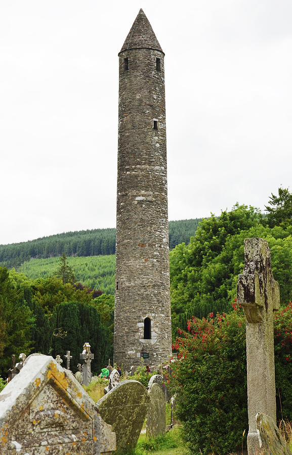 Glendalough Round Tower Rising Above Irish Graveyard County Wicklow Ireland Photograph by Shawn OBrien