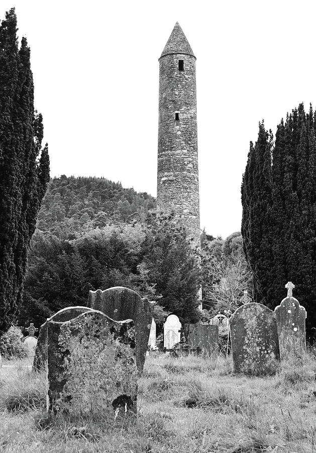 Glendalough Round Tower Watching Over Irish Graveyard County Wicklow Ireland Black and White Photograph by Shawn OBrien