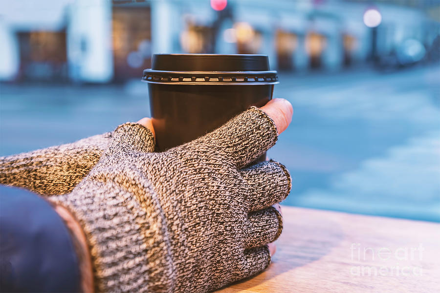 Gloved hands holding coffee cup Photograph by Sophie McAulay