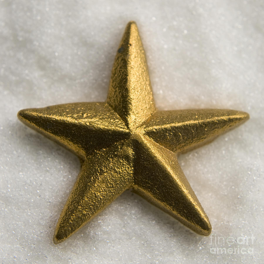 Gold star on snow Photograph by Clayton Bastiani
