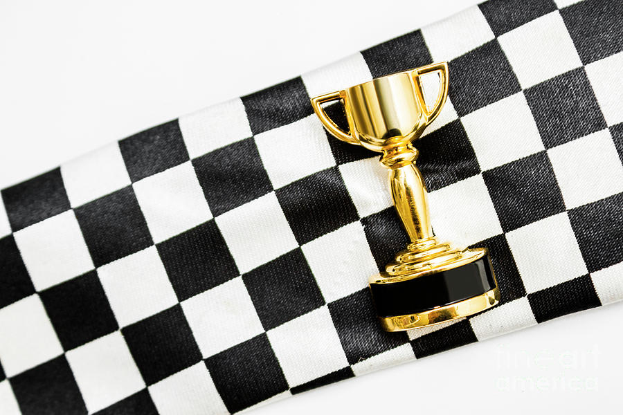 Cup Photograph - Gold trophy on a checked sport flag by Jorgo Photography