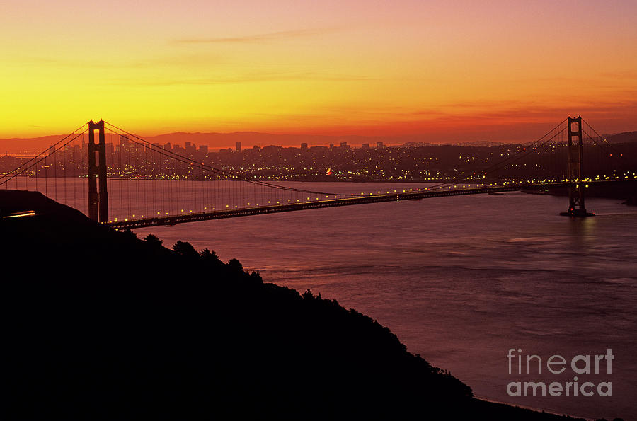 Golden Gate Bridge at Sunrise with City Lights Photograph by Jim Corwin
