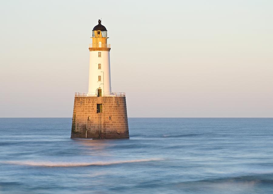 Golden light and sea waves at Rattray Head Lighthouse Photograph by Stephen Taylor
