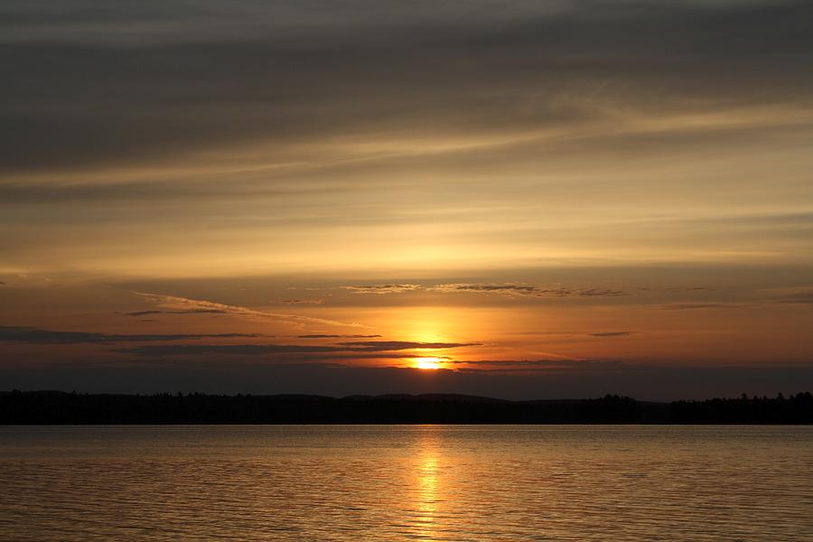 Golden Sun Peeks through Orange Clouds at Sunrise Photograph by GinA ...
