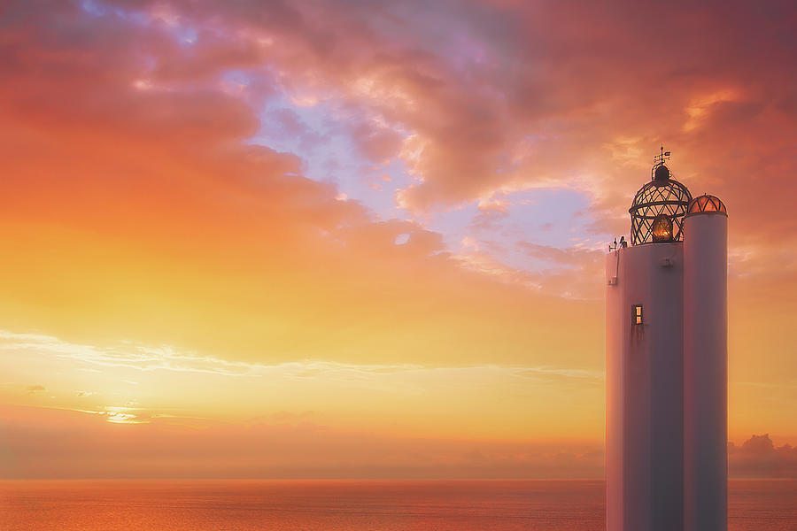 Gorliz lighthouse at sunset Photograph by Mikel Martinez de Osaba