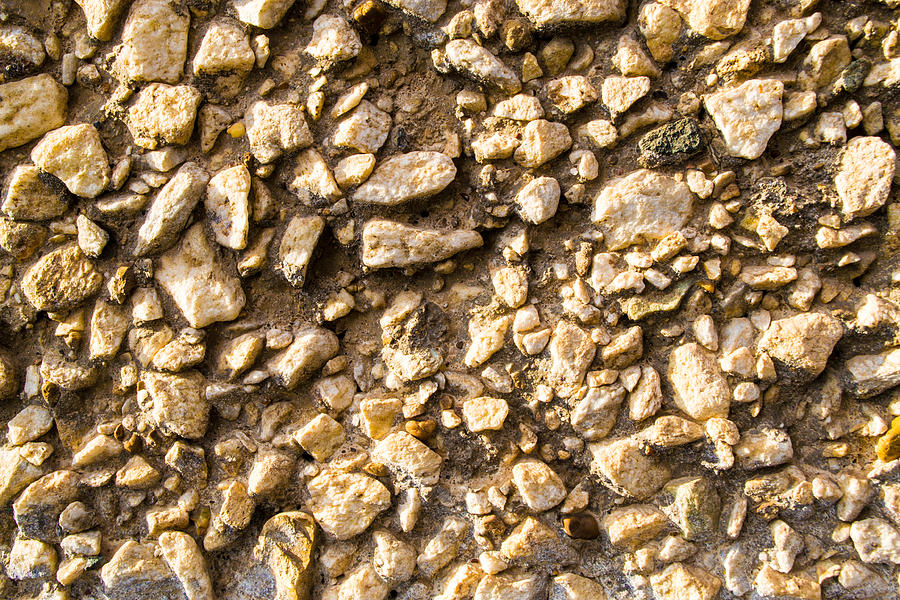 Gravel stones on a wall Photograph by John Williams