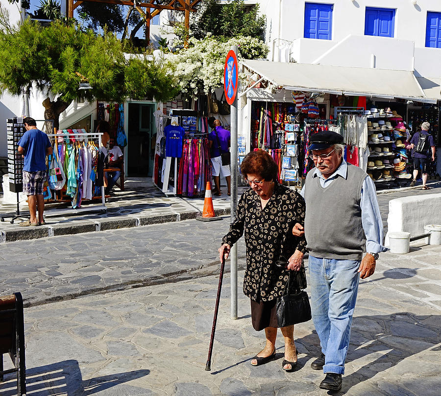 Greek Couple Strolling Through Town On Mykonos Greece Photograph by Rick Rosenshein