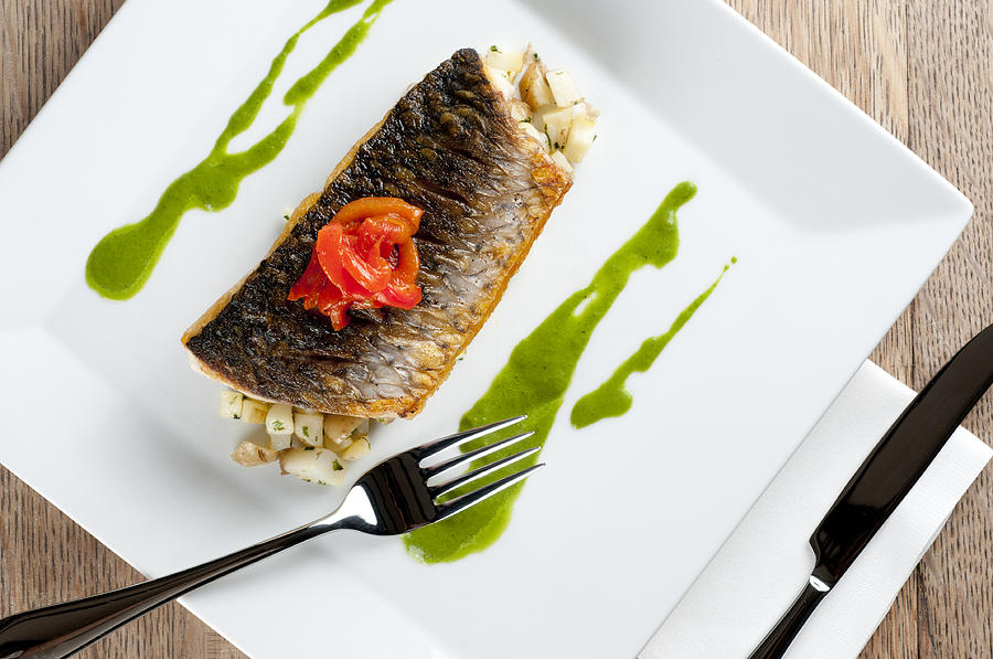 Fish Photograph - GREY MULLET WITH WATERCRESS SAUCE presented on a square white plate with cutlery and napkin by Andy Smy