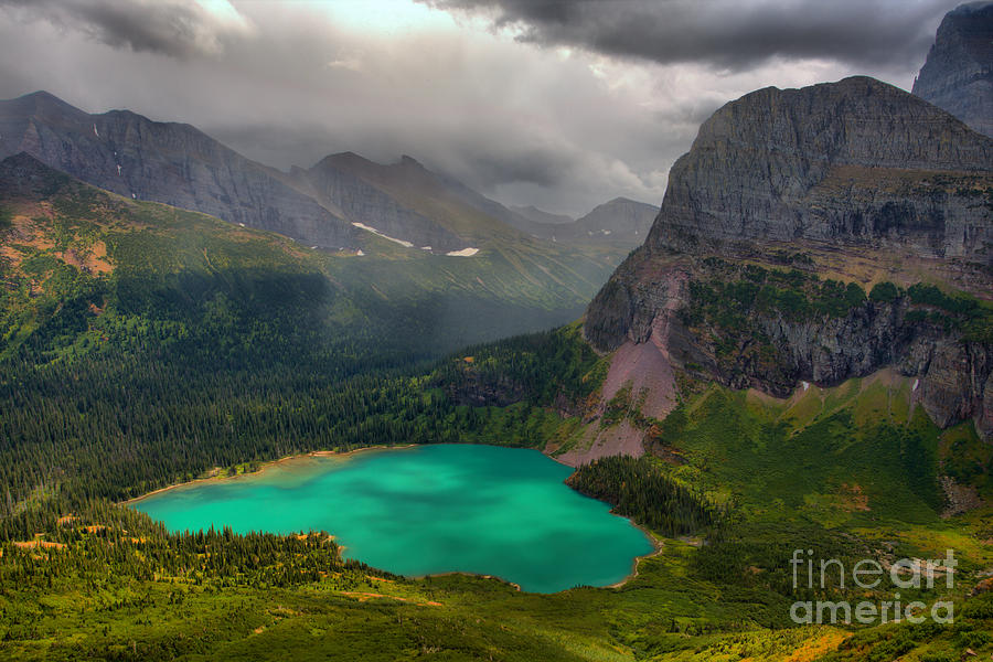 Grinnell Lake Shining Under The Storm Photograph by Adam Jewell